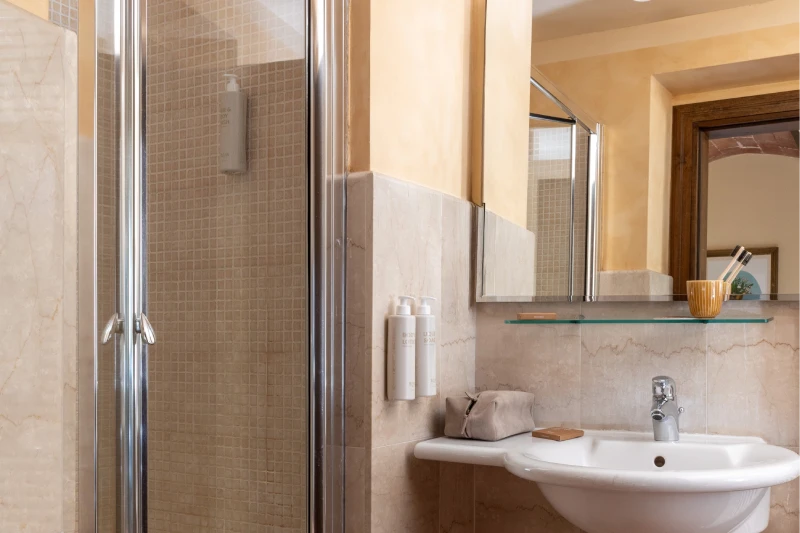 Classic room bathroom with shower, sink and stone finishes in elegant Chianti villa at Barberino Tavarnelle - Villa San Filippo, BZAR hotels in Tuscany