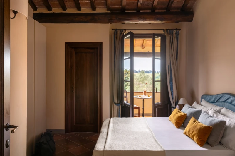 Family room with stone fireplace, living area and direct access to panoramic garden in Tuscany at Barberino Tavarnelle - Villa San Filippo, BZAR hotels in Tuscany