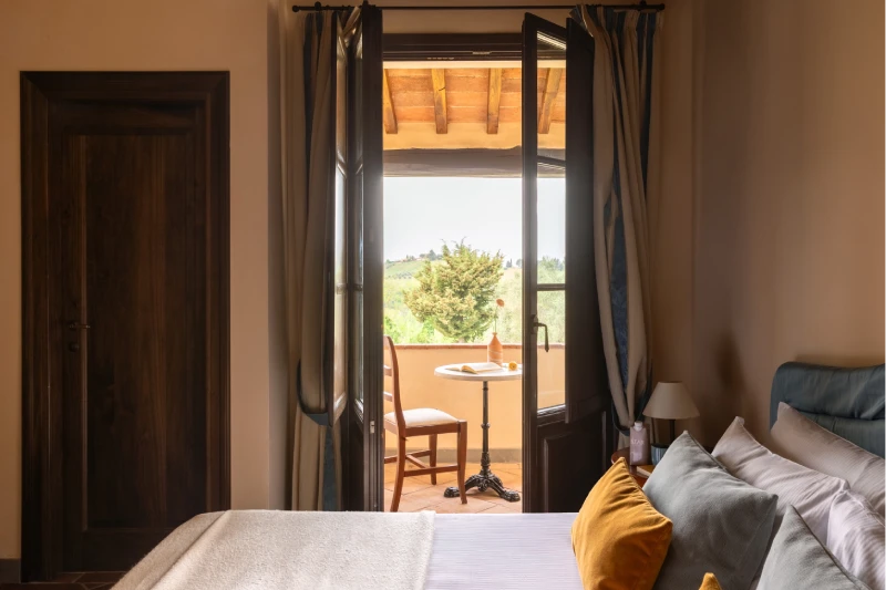 Family room with double bed and balcony access overlooking Chianti hills in Barberino Tavarnelle - Villa San Filippo, BZAR hotels in Tuscany