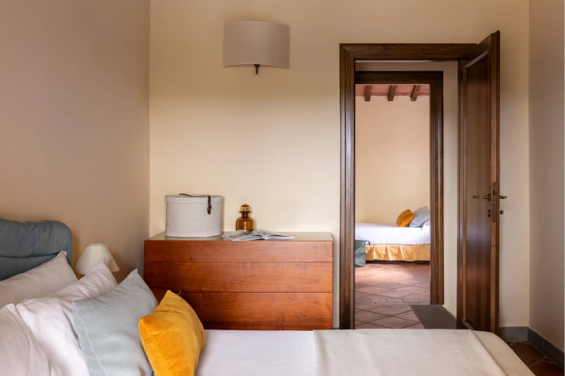 Family room with balcony and small table overlooking panoramic Tuscan hills in Barberino Tavarnelle, Chianti - Villa San Filippo, BZAR hotels in Tuscany