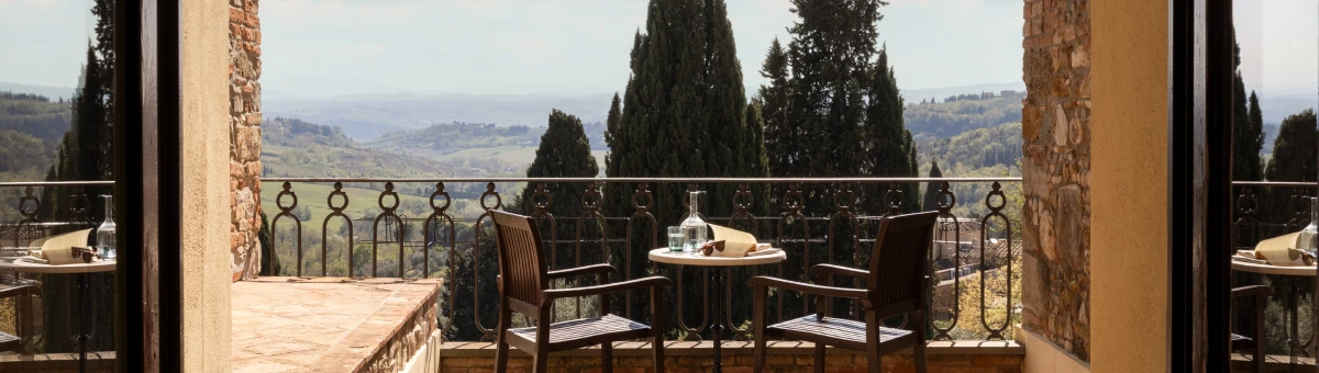 Panoramic terrace with table and chairs overlooking Chianti hills in Tuscany at Barberino Tavarnelle - Villa San Filippo, BZAR hotels in Tuscany