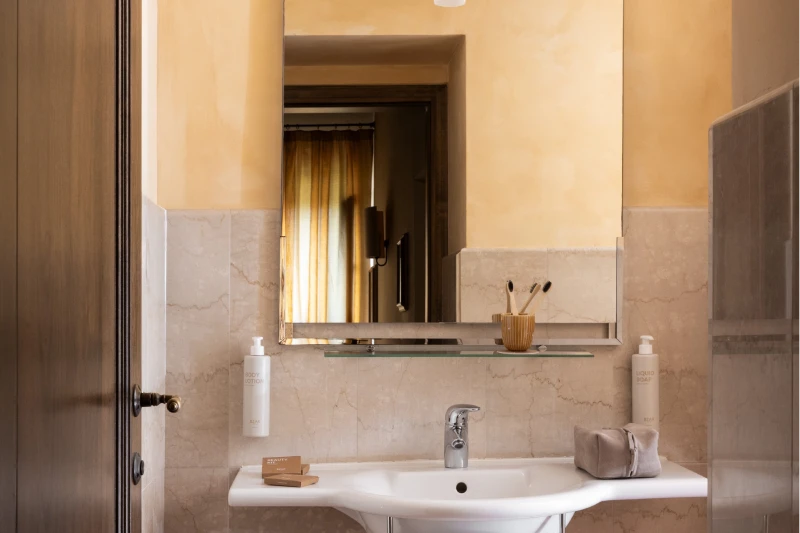 Bright private bathroom with marble finishes and modern amenities in an elegant countryside room in Tuscany - Villa San Filippo, BZAR hotels in Tuscany