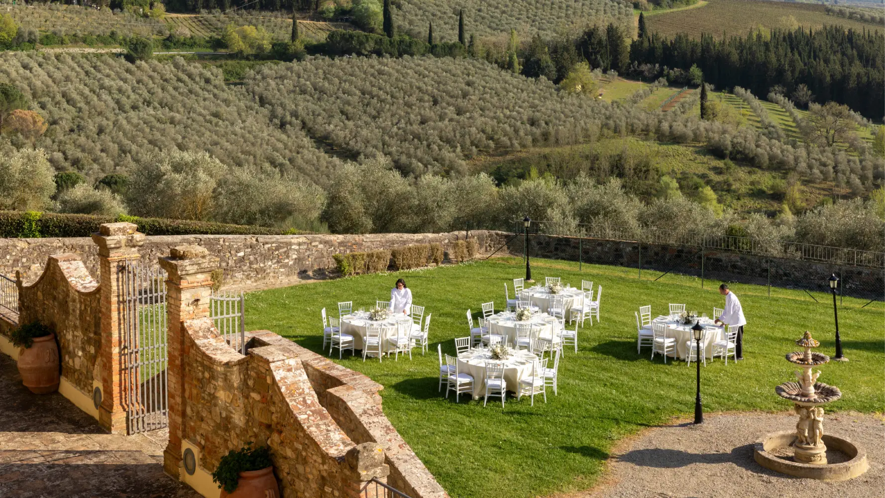 Outdoor wedding setup with elegant tables surrounded by the rolling countryside of Tuscany's Chianti region - Villa San Filippo, BZAR hotels in Tuscany