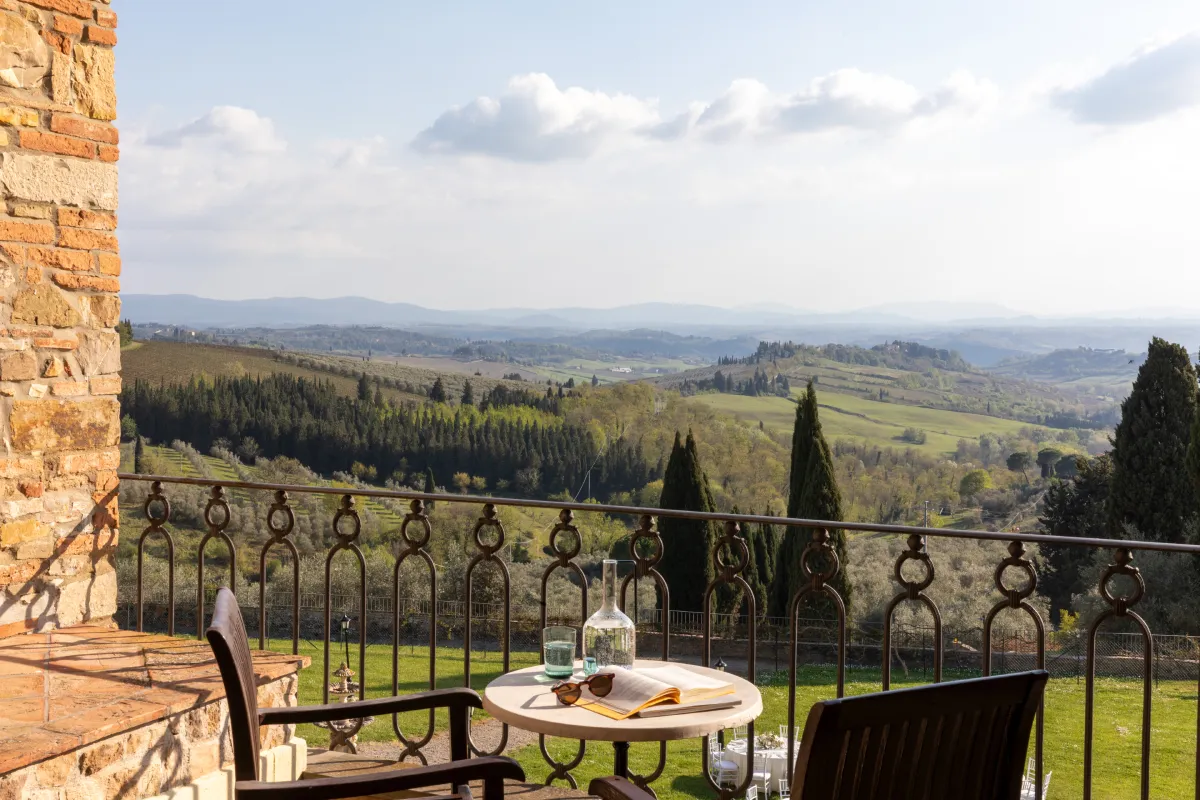 Panoramic terrace with table and chairs overlooking Chianti hills in Tuscany at Barberino Tavarnelle - Villa San Filippo, BZAR hotels in Tuscany